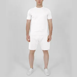 Full body view of a male model wearing a casual white short sleeve t-shirt and shorts set