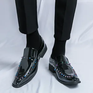 Trendy black patent leather loafers featuring colorful metallic studs and pointed toe