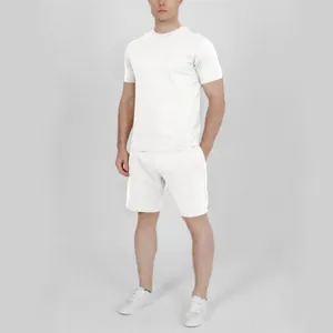 Men's minimalist white summer shorts set with short sleeve t-shirt and casual sneakers