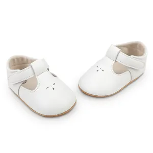 Detailed view of white faux leather baby princess shoes with flower laser cut-outs
