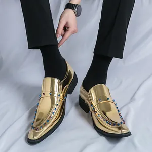 Luxury men's pointed-toe loafers in gold metallic finish with multi-colored studs