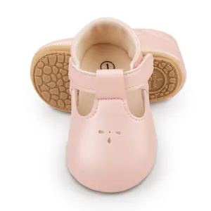 Macro detail of pink baby pre-walker shoes featuring anti-slip soles and T-strap velcro