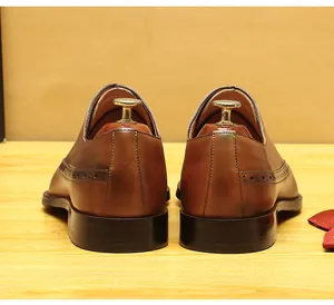 Rear view of brown leather Brogue Oxford shoes with hand-finished details and wooden trees