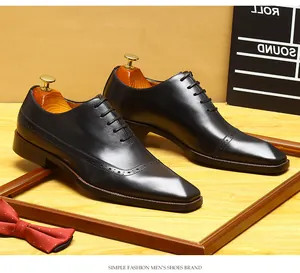 Close-up detail of black leather Brogue Oxford shoes with intricate wingtip carvings