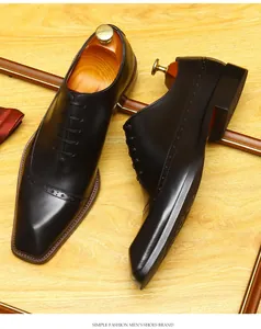 Close-up view of black leather brogue oxford shoes with elegant perforated detailing