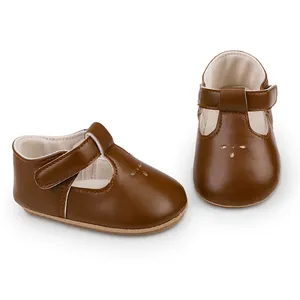 Detailed view of brown leather baby walking shoes with T-strap and velcro