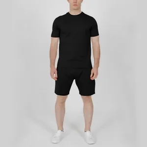 Professional full body view of men's black solid color short sleeve T-shirt and shorts set