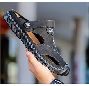 Detail shot of breathable black leather men's sandal with hollow-out design