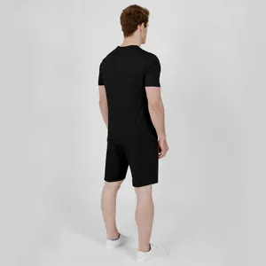 Back view of a man wearing a black casual short-sleeve t-shirt and shorts set