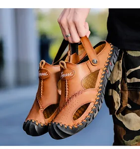 Close-up of brown leather men's sandals featuring breathable hollow design and Sport logo