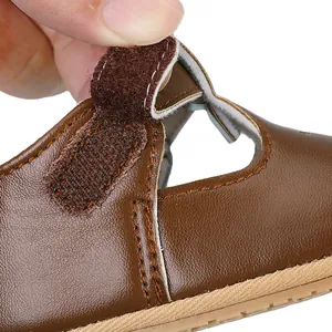 Close-up view of brown baby leather princess shoe showing hook and loop strap detail
