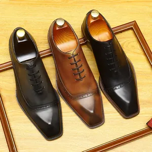 Classic men's leather brogue Oxford shoes with hand-burnished finish for business formal wear.