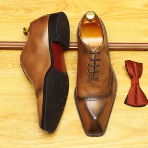 Premium brown hand-burnished leather Oxford shoes with elegant wingtip brogue details.