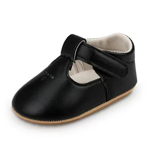 Close-up detail of black T-strap baby princess shoes with flexible rubber sole.