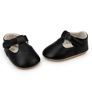 Detail view of black T-strap baby princess shoes with hook and loop strap closure