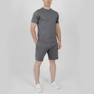 Full body view of a model wearing a premium gray men's casual T-shirt and shorts set