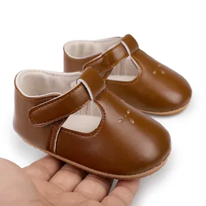 Macro view of brown baby girl leather princess shoes featuring velcro straps and rubber soles