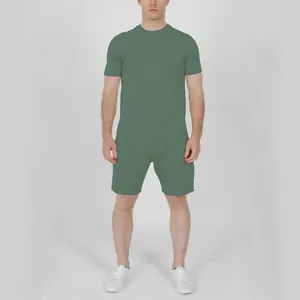 Full body view of a man wearing a sage green t-shirt and matching shorts set