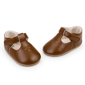 Classic brown faux leather baby dress shoes with T-strap and floral cutouts for infants