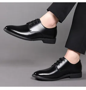 Professional side view of classic black leather dress shoes paired with formal suit pants