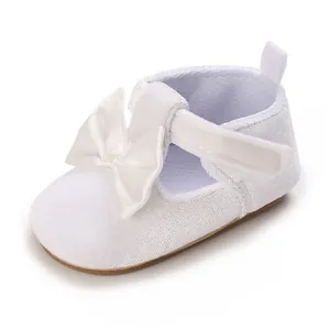 Detailed view of a white baby walker shoe featuring a soft sole and decorative bow