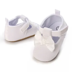 Detailed view of white soft-sole baby pre-walker shoes with elegant bow decoration