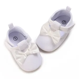 Detailed view of white soft sole baby pre-walker shoes featuring an elegant ribbon bow design