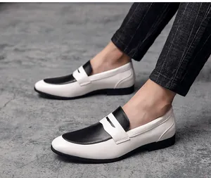 Close-up of men's pointed-toe loafers with stylish black and white contrast design.
