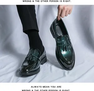 Close-up of glossy dark green men's loafers with elegant tassel detail and shine