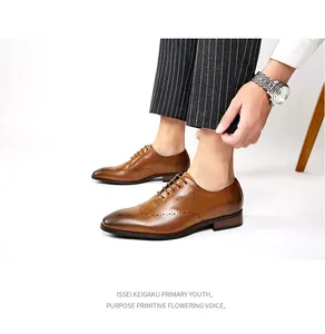 Detailed view of men's brown hand-rubbed leather Brogue shoes on model in a suit