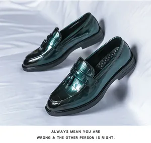 Close-up detail of premium dark green glossy loafers with crocodile pattern and tassels