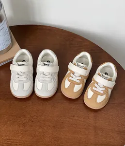 Selection of stylish toddler sneakers in grey and tan colorways for boys and girls.