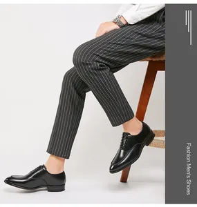 Detailed view of elegant black leather Oxford dress shoes for men worn with striped trousers