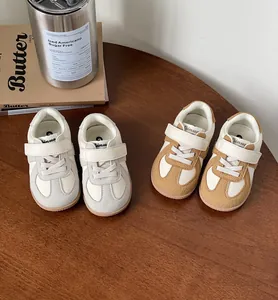 Detail view of cozy leather toddler sneakers in white and brown tones for kids.