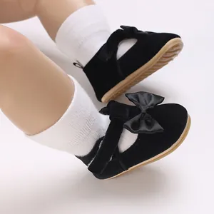 Detailed view of black velvet baby soft sole prewalker shoes featuring a satin bow