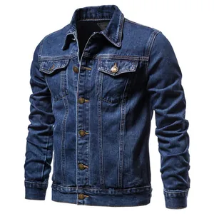 Detail of a classic blue denim jacket for men featuring a slim fit and metal buttons.