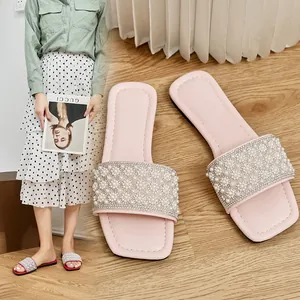 Pink square-toe flat slippers with pearl and rhinestone embellishments for casual beach wear
