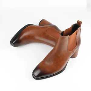 High-angle view of brown men's Chelsea boots with elegant burnished toe and block heel