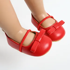 Detailed macro shot of red baby princess shoes featuring a cute bow and soft sole design