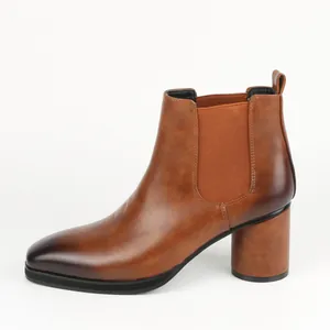 Side profile of a brown leather Chelsea boot with a chunky high heel and burnished toe