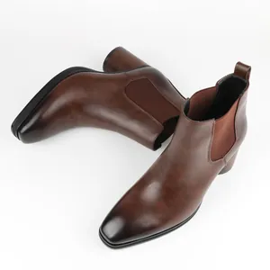 Detailed view of stylish brown men's Chelsea boots with polished leather finish.