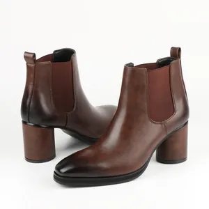 Close-up of brown high-heeled Chelsea boots with vintage leather finish