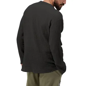 Back view of a men's black seersucker long-sleeve casual shirt with textured fabric
