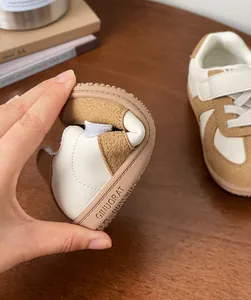 Flexible soft-sole baby walking shoes for toddlers with white and tan patchwork design