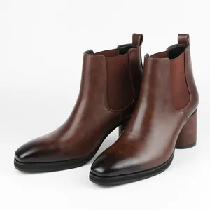 Detailed side view of stylish brown leather Chelsea boots with chunky heels and gradient toe.
