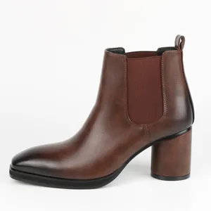 Side view of stylish brown men's Chelsea boots featuring a block heel and gradient toe