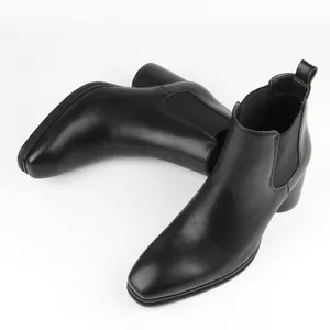 Detailed view of stylish black leather Chelsea boots for men with elastic side panels