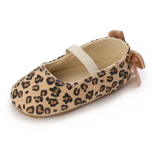 Detailed view of a leopard print baby girl shoe featuring a soft non-slip sole and bow
