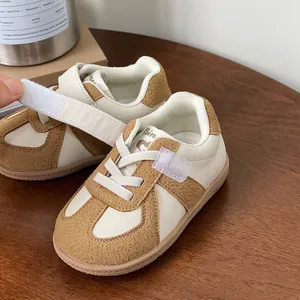 Casual soft sole baby walking shoes with white and brown contrast panels.