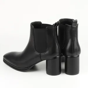 Rear view of black Chelsea boots featuring a thick block heel and elastic side panels